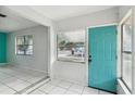 Front entry with teal door and tiled floor at 2901 Dr Martin Luther King Jr S St, St Petersburg, FL 33705