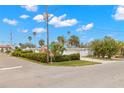 Mid-century modern home with a landscaped yard and palm trees at 204 163Rd Ave, Redington Beach, FL 33708