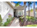 Welcoming front entry with a brick walkway and seating area at 2756 Tarragona Way, Wesley Chapel, FL 33543