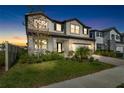 Two story home with a neutral color palette and landscaping at 33157 Rosewood Bark Way, Wesley Chapel, FL 33545