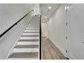 Modern staircase with wood steps and sleek metal railing at 3450 Desert Trunk Ct, Tampa, FL 33614