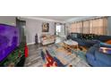 Living room with blue couch, TV, and area rug at 5117 12Th S Ave, Gulfport, FL 33707