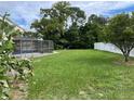 Large backyard with a screened pool and plenty of grass at 5404 Glover Dr, Weeki Wachee, FL 34607