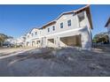 New construction townhome development; gray siding, attached garages at 5725 Desert Rose Pl, Tampa, FL 33615