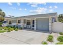 A charming single-story home featuring a driveway with manicured front yard landscaping at 709 Mandalay Ave, Clearwater Beach, FL 33767
