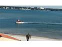 Boat on calm water with distant city skyline at 855 Bayway Blvd # 902, Clearwater Beach, FL 33767