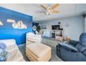 Bright living room features comfortable seating, ceiling fan, and decor at 12760 Indian Rocks Rd # 582, Largo, FL 33774