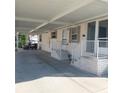 Covered carport with golf cart and access to home entrance at 1760 Dorothy Blvd, Lutz, FL 33558
