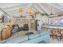 Open concept kitchen and living area with island and vaulted ceiling at 1808 Gulf Blvd # 1, Indian Rocks Beach, FL 33785