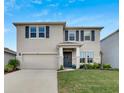 Two-story house with a two-car garage and landscaped lawn at 182 Mangrove Manor Dr, Apollo Beach, FL 33572