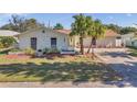 Charming single-story home with well-manicured lawn and palm trees at 2661 Peachtree E Cir, Clearwater, FL 33761