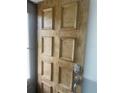 Wood front door with a keypad lock at 3259 Hilary Cir # 1A, Palm Harbor, FL 34684