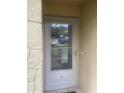 White front door with glass panels and a keypad lock at 3259 Hilary Cir # 1A, Palm Harbor, FL 34684