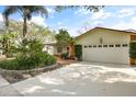 Front view of house with driveway, landscaping, and attached garage at 409 Hickory Tree Cir, Seffner, FL 33584