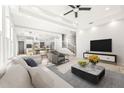 Open living room showcasing kitchen, staircase, and ample natural light at 6117 E 113Th Ave, Temple Terrace, FL 33617