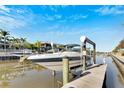 Waterfront home featuring a private boat dock with a lift on a sunny day at 620 Mirabay Blvd, Apollo Beach, FL 33572