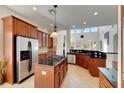 Spacious kitchen with an island, stainless steel appliances, and dark wood cabinets at 620 Mirabay Blvd, Apollo Beach, FL 33572