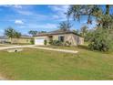 House exterior view, showing a tan house with landscaping at 807 Garden Oaks Sq, Seffner, FL 33584