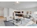 Open-concept living room and kitchen with modern decor and plenty of natural light at 807 Garden Oaks Sq, Seffner, FL 33584
