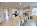Island kitchen with granite counters and stainless steel appliances at 10741 Buttercup Ct, Venice, FL 34293