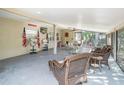 Spacious screened porch with wicker furniture at 1601 Lakeview Rd, Clearwater, FL 33756
