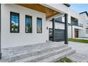 Stylish front porch with gray brick pavers and modern black framed windows at 3402 W Grace St, Tampa, FL 33607