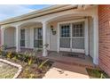 Inviting front porch with brick walkway and landscaping at 3438 Moog Rd, Holiday, FL 34691