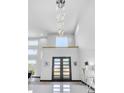 Bright, light-filled foyer with double doors, high ceilings, and a stunning chandelier at 6524 6Th N Ave, St Petersburg, FL 33710