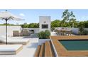 Relaxing rooftop deck area with outdoor seating, dining, a mini-pool, and scenic views for leisure and entertaining at 7602 Antilla St, Tampa, FL 33625