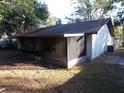 Back of house with screened porch and a detached structure at 8510 Renald Blvd, Temple Terrace, FL 33637