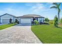 Single-story home with a paved driveway and landscaped front yard at 8705 Coastal Key Way, Parrish, FL 34219