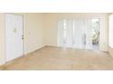 Living room with neutral walls, carpet, and sliding glass doors at 12119 Sunny Glen Ln # F1, Hudson, FL 34669