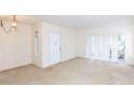 Bright living room featuring carpet flooring and sliding glass doors at 12119 Sunny Glen Ln # F1, Hudson, FL 34669