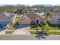House near a lake with a large yard and two-car garage at 1406 Deerbourne Dr, Wesley Chapel, FL 33543