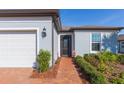 Front entry with brick walkway leading to front door at 19494 Sea Glass Cir, Land O Lakes, FL 34638