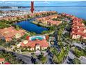 Wide aerial view of waterfront community with pool and clubhouse at 2733 Via Cipriani # 830A, Clearwater, FL 33764