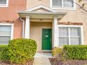 Green front door with a wreath, showcasing curb appeal at 30405 Elderwood Dr, Wesley Chapel, FL 33543