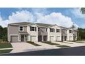 New townhouses with attached garages and landscaping at 31270 Midnight Sun Way, Wesley Chapel, FL 33545