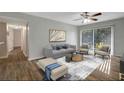 Bright living room with wood-look floors, a comfy sofa, and two armchairs at 7020 Cognac Dr # 3, New Port Richey, FL 34653