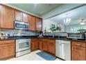 Modern kitchen featuring stainless steel appliances and wood cabinets at 10280 Post Harvest Dr, Riverview, FL 33578