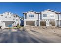 New townhome development featuring attached garages and modern design at 5727 Desert Rose Pl, Tampa, FL 33615