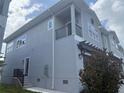 Attractive two-story home featuring a charming balcony, covered entry, and freshly painted exterior at 5727 Desert Rose Pl, Tampa, FL 33615