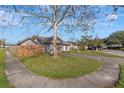 Single-story house with a tree and grassy front yard at 7908 E White Water Ct, Tampa, FL 33637