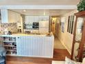 Efficient kitchen with white cabinets, ample counter space, and a breakfast bar at 9790 66Th N St # 340, Pinellas Park, FL 33782