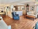Open living space with a view of the kitchen and a comfy recliner at 9790 66Th N St # 340, Pinellas Park, FL 33782