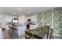 Kitchen dining area with a table for six and tropical-themed wallpaper at 18125 Canopy Pl, Lakewood Ranch, FL 34211