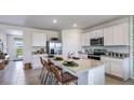 Kitchen with white cabinets, granite countertops and island at 18128 Canopy Pl, Lakewood Ranch, FL 34211