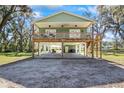 Front view of an elevated home with a large deck at 39744 Amber Ave, Zephyrhills, FL 33540