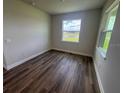 Bright bedroom featuring hardwood floors and a large window offering natural light at 4314 Pullet Ct, Lakewood Ranch, FL 34211