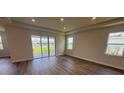 Spacious living room with hardwood floors and sliding glass doors leading to the backyard at 4314 Pullet Ct, Lakewood Ranch, FL 34211